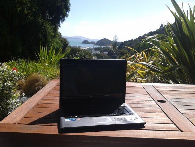 Image of laptop in Paihia with scene background